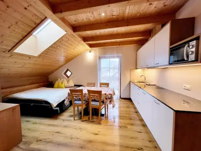 a room with a bed and a table and chairs at Krebslechnerhof in Brunico