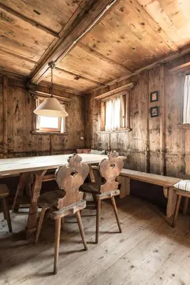 a dining room with a table and two chairs at Hütterhof Passeiertal in San Martino
