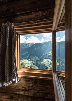 a window with a view of a mountain view at Hütterhof Passeiertal in San Martino