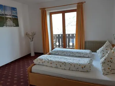 a bedroom with two beds and a window at Stuberhof in Rifiano