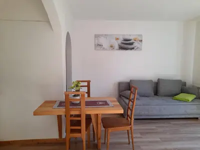 a dining room with a table and a couch at Stuberhof in Rifiano