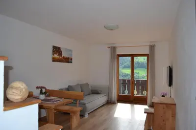 a living room with a couch and a table at Stuberhof in Rifiano