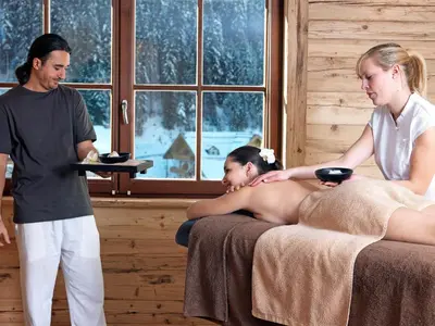 a man is giving a woman a massage at Granbaita Dolomites in Selva di Val Gardena