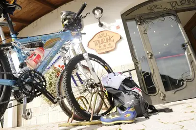 a bike parked on a rack in a garage at Alpine Touring Hotel-petfriendly in Pozza di Fassa