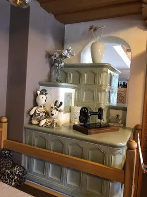 a green hutch with two stuffed animals on top of it at Alpine Touring Hotel-petfriendly in Pozza di Fassa