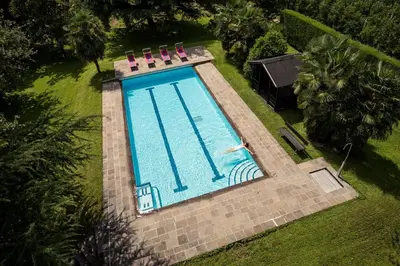 an overhead view of a swimming pool with a person in it at Apartments Obermayr in Lana