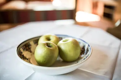 a bowl of green apples sitting on a table at Apartments Obermayr in Lana