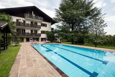a swimming pool in front of a building at Apartments Obermayr in Lana
