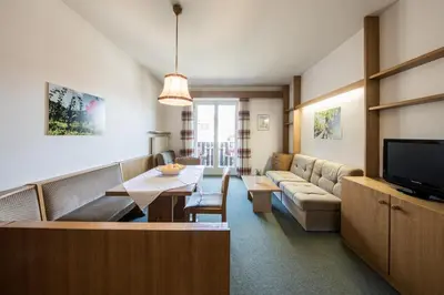 a living room with a couch and a table at Apartments Obermayr in Lana