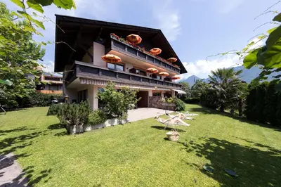 a house with a lawn in front of it at Apartments Feyerlin in Lana