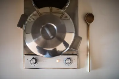 a metal fan sitting next to a wooden spoon at Apartments Feyerlin in Lana