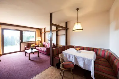 a living room with a table and a couch at Apartments Feyerlin in Lana