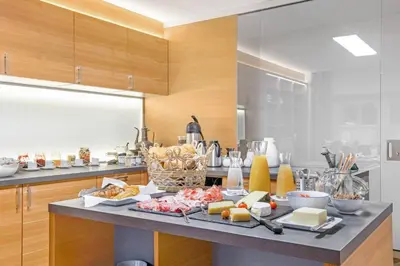 a kitchen with a table with food on it at Residence krUma in Valdaora