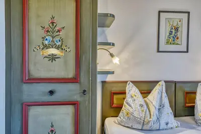 a bedroom with a door and a bed with pillows at Villa Ladurner in Tirolo