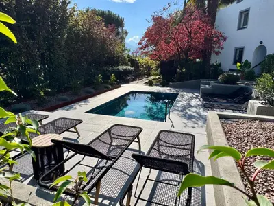 a patio with chairs and a swimming pool at Villa Ladurner in Tirolo