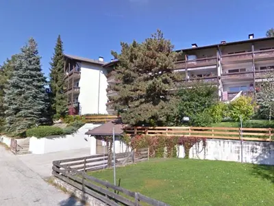 a building with a fence in front of a yard at Apartment Matilde in Vols am Schlern