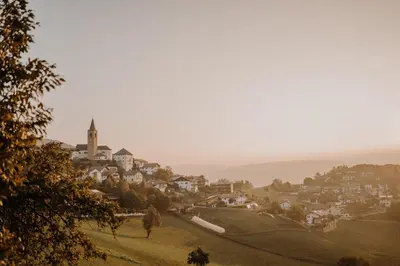 a small town on a hill with a church at Hotel & Gasthof zum Hirschen in San Genesio Atesino