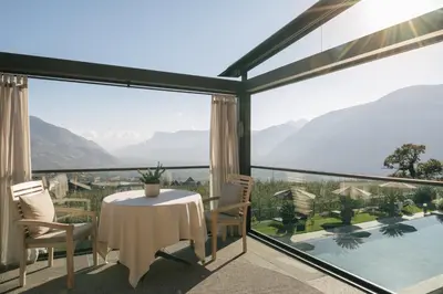 a view from the balcony of a house with a table and chairs at Hotel Patrizia in Tirolo