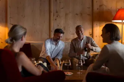 a group of people sitting around a table with wine glasses at Hotel Patrizia in Tirolo