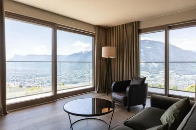 a living room with a couch and a table at Hotel Patrizia in Tirolo