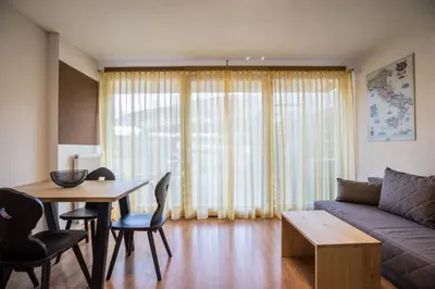 a living room with a couch and a table at Appartements Durnbrunn in Valdaora