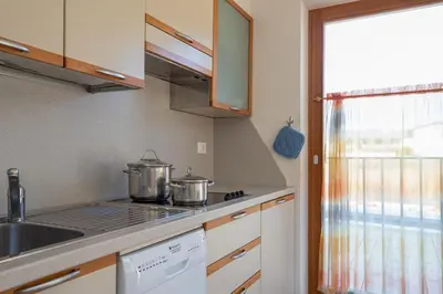a small kitchen with two pots on the stove at Appartements Durnbrunn in Valdaora