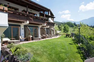 a house with a lawn in front of it at Hotel Grien in Ortisei