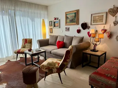 a living room with a couch and two chairs at Da Renata in Valdaora