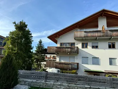 a building with balconies and a fence in front of it at Da Renata in Valdaora