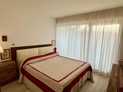a bedroom with a bed and a large window at Da Renata in Valdaora
