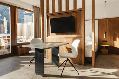 a hotel room with a table and a tv at Gran Tubla in Ortisei