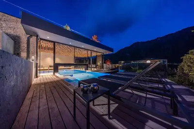 a house with a swimming pool on a wooden deck at Gran Tubla in Ortisei