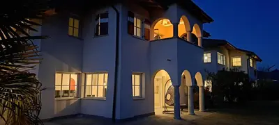 a white building with a clock on the top of it at Gutshof Rellich in Termeno