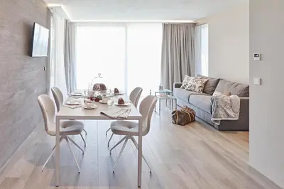a living room with a table and chairs and a couch at The View Luxury Suites in Lagundo