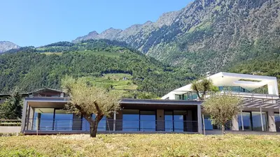 a house with a mountain in the background at The View Luxury Suites in Lagundo