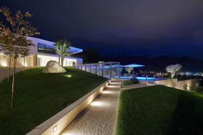 a house with a garden with a rock and lights at The View Luxury Suites in Lagundo