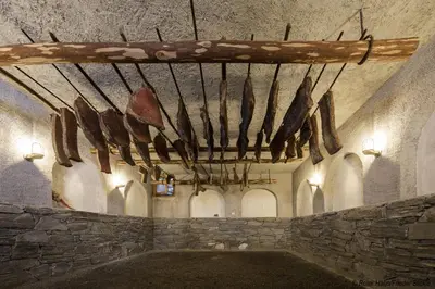 a rack of meat hanging from the ceiling of a building at Obermoserhof in Feldthurns