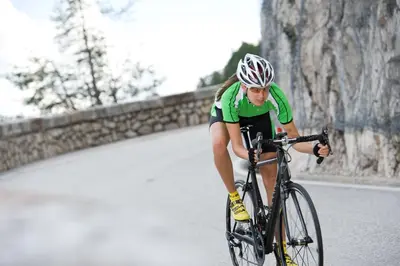 a person riding a bike down a road at Hotel-Garni Ehrenfels in Schenna