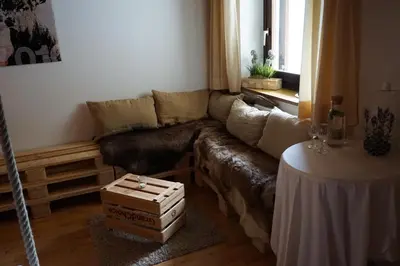 a living room with a couch and a table at BUEHLERHOF Urlaub mit Kind & Hund, Obst-& Weingut, Brixen in Rosa
