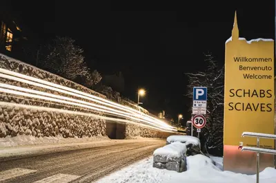 a sign on a snowy road at night at BUEHLERHOF Urlaub mit Kind & Hund, Obst-& Weingut, Brixen in Rosa