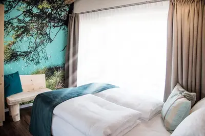 a bedroom with a bed and a large window at Chalet Schmied in Terento