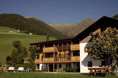 a large building with a table in front of it at Chalet Schmied in Terento