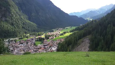 a small town in a valley in the mountains at CasaMau Trilo in Campitello di Fassa