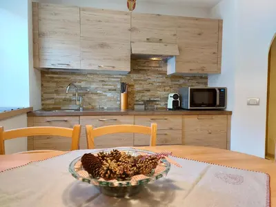a bowl of pine cones on a table in a kitchen at Casa Rita in Tesero