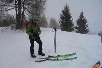 a man standing in the snow with skis in the snow at Ciasa Medalghes in San Martino in Badia