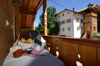a table with a basket of bread on a balcony at Agriturismo Anví in Badia