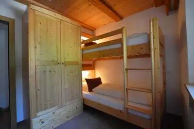 a bunk bed in a room with a bunk bed in a cabin at Agriturismo Anví in Badia