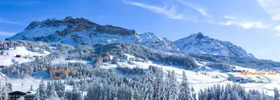a mountain covered in snow with trees and a building at Agriturismo Anví in Badia
