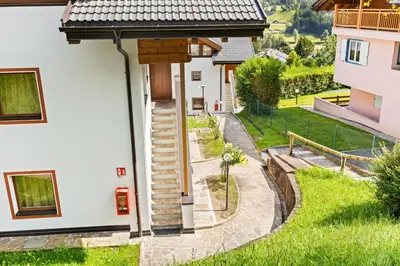 a house with a view of a yard at Residence Des Alpes in Cavalese