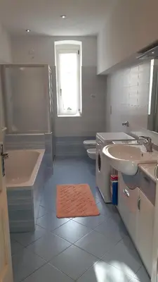 a bathroom with a sink and a tub and a toilet at Casa da Aldo in Castelfondo